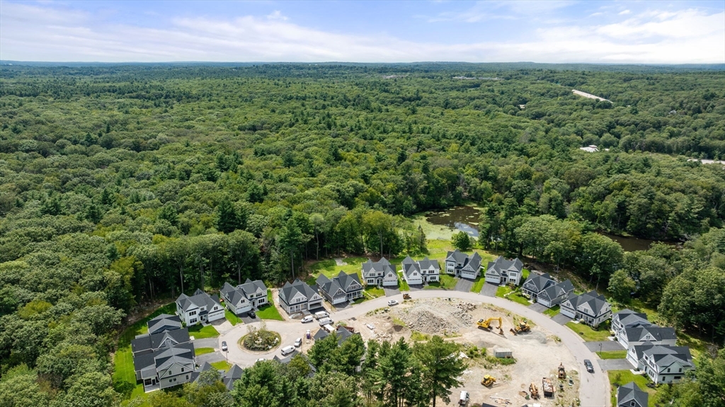 106 Horrigan Drive, Unit 21 Dedham, MA 02026 - Photo 3 of 32 an aerial view of a house with a yard