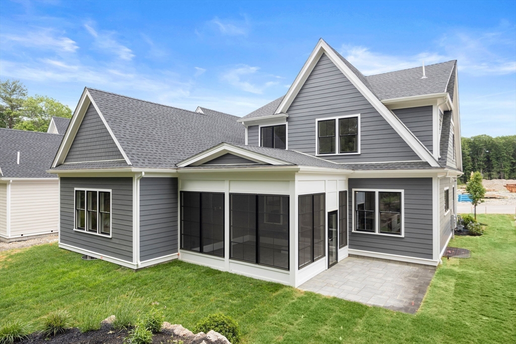 106 Horrigan Drive, Unit 21 Dedham, MA 02026 - Photo 31 of 32 a view of a yard in front of a house with plants and large tree