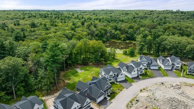 an aerial view of a house with swimming pool garden and patio