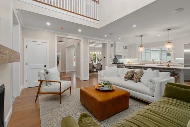 a living room with furniture and a dining table with kitchen view