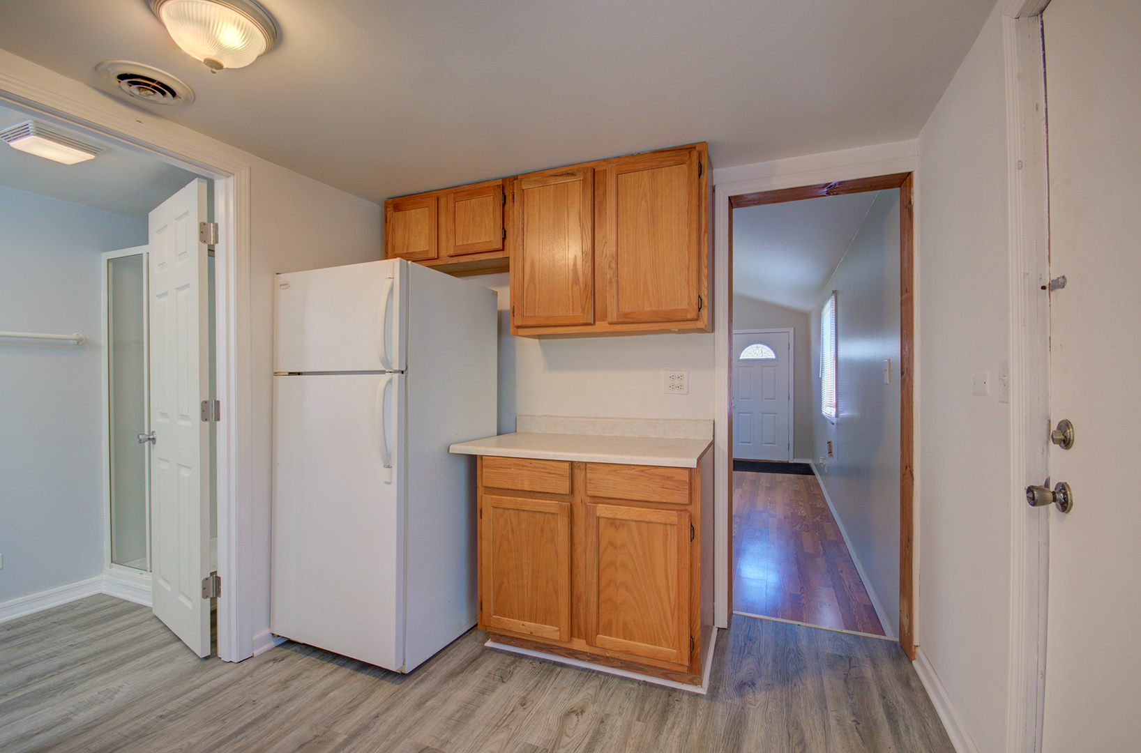 2024 Plainfield Road Crest Hill, IL 60403 - Photo 9 of 20 a view of a kitchen with wooden floor and a refrigerator