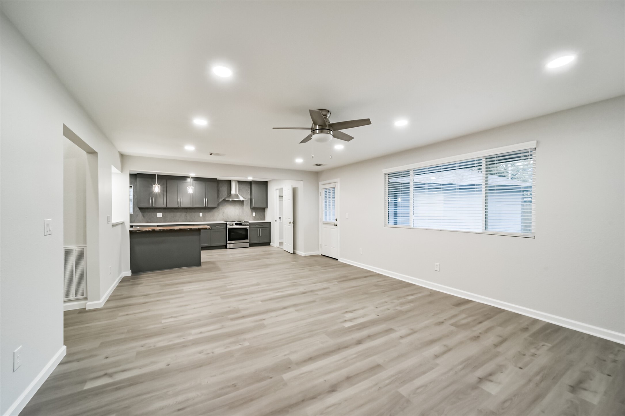 15610 Ripplewind Lane Houston, TX 77068 - Photo 9 of 44 a view of a kitchen with a sink and dishwasher a refrigerator with wooden floor