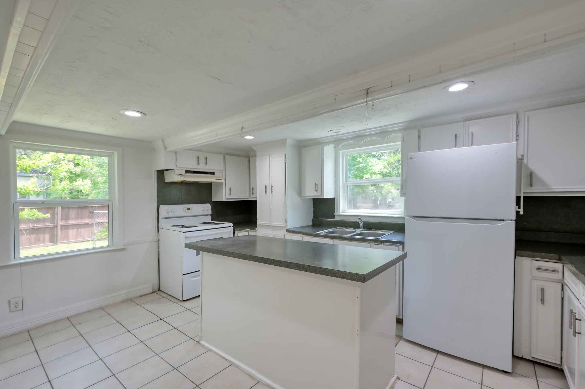 29906 Hunters, Unit B Magnolia, TX 77355 - Photo 11 of 25 a kitchen with kitchen island a sink appliances and a counter top space