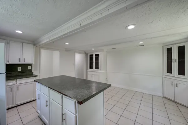 a kitchen with a sink a microwave and cabinets