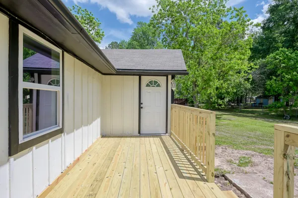 a view of backyard with a deck and wooden floor