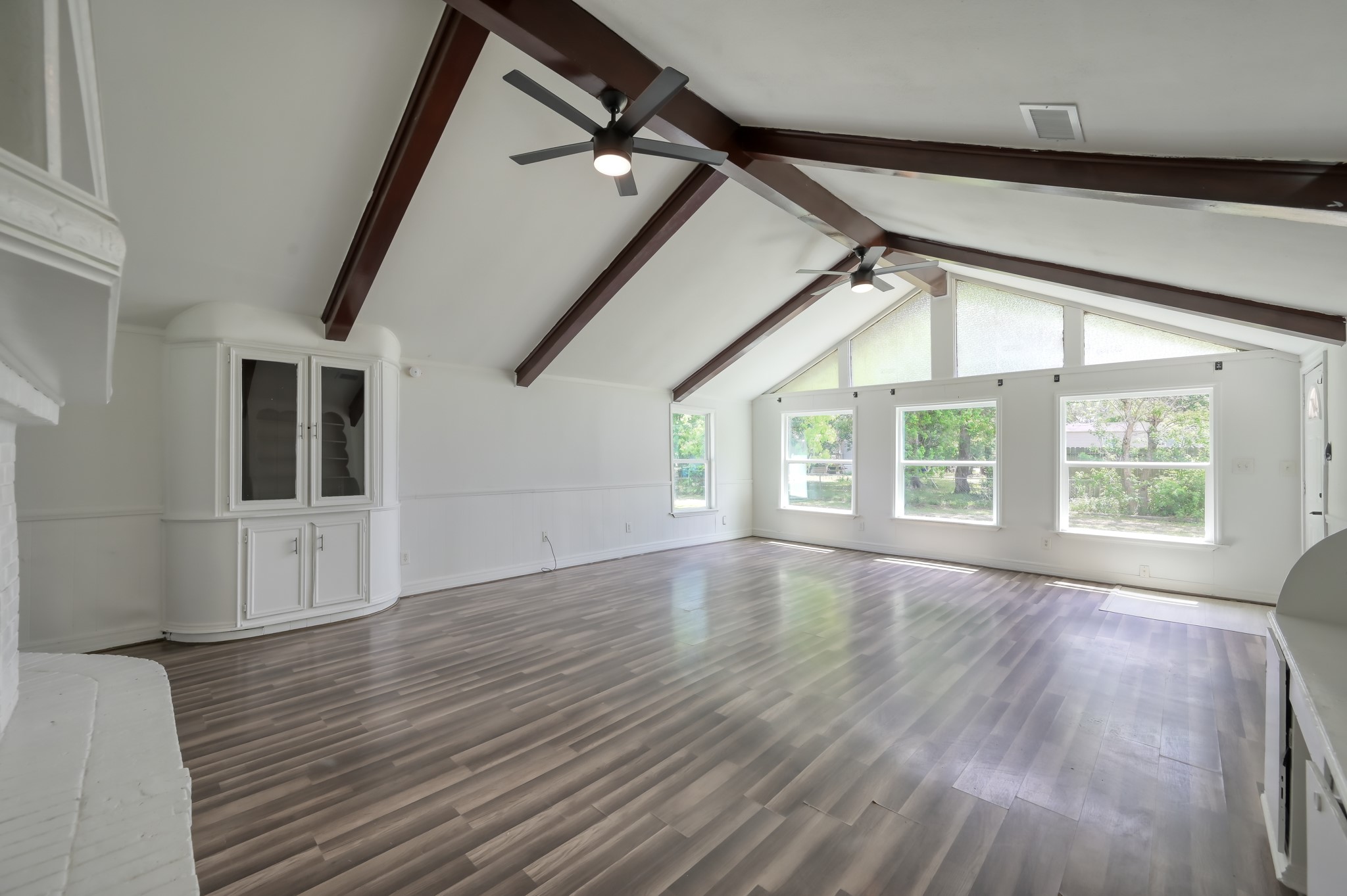29906 Hunters, Unit B Magnolia, TX 77355 - Photo 6 of 25 a view of an empty room with wooden floor and a window