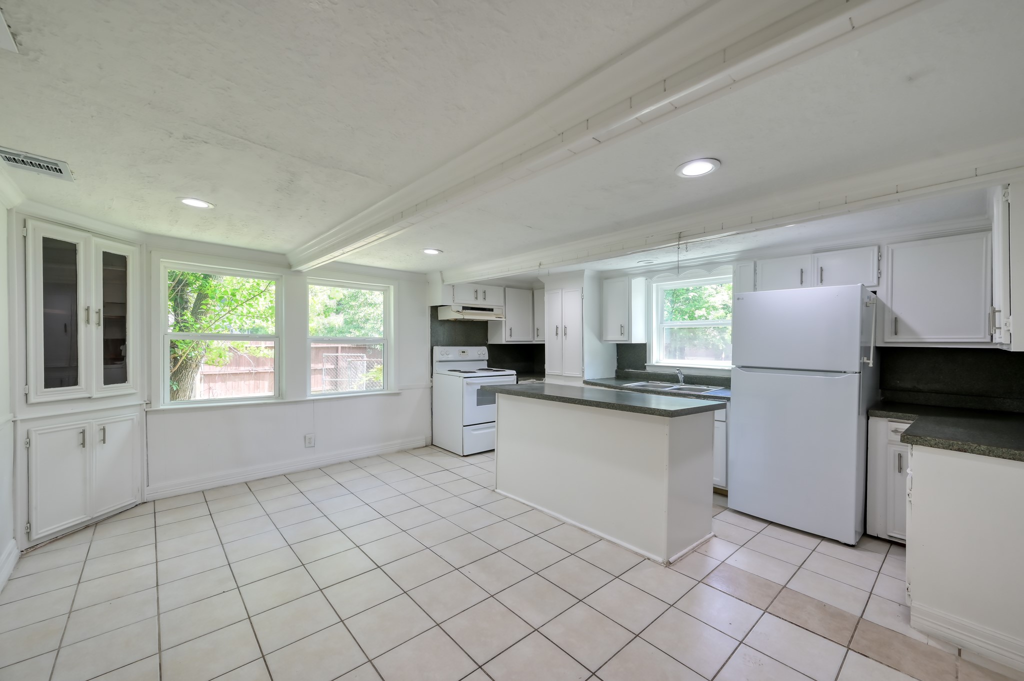 29906 Hunters, Unit B Magnolia, TX 77355 - Photo 7 of 25 a kitchen with stainless steel appliances a refrigerator sink and microwave