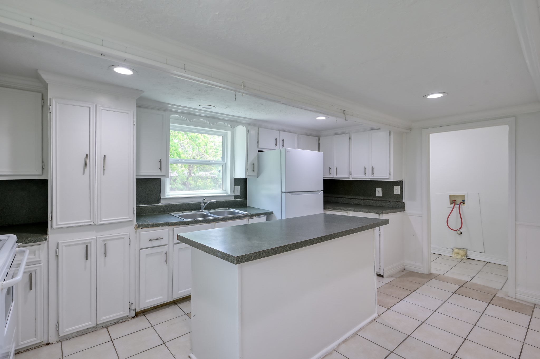 29906 Hunters, Unit B Magnolia, TX 77355 - Photo 9 of 25 a kitchen with stainless steel appliances granite countertop a sink and a stove
