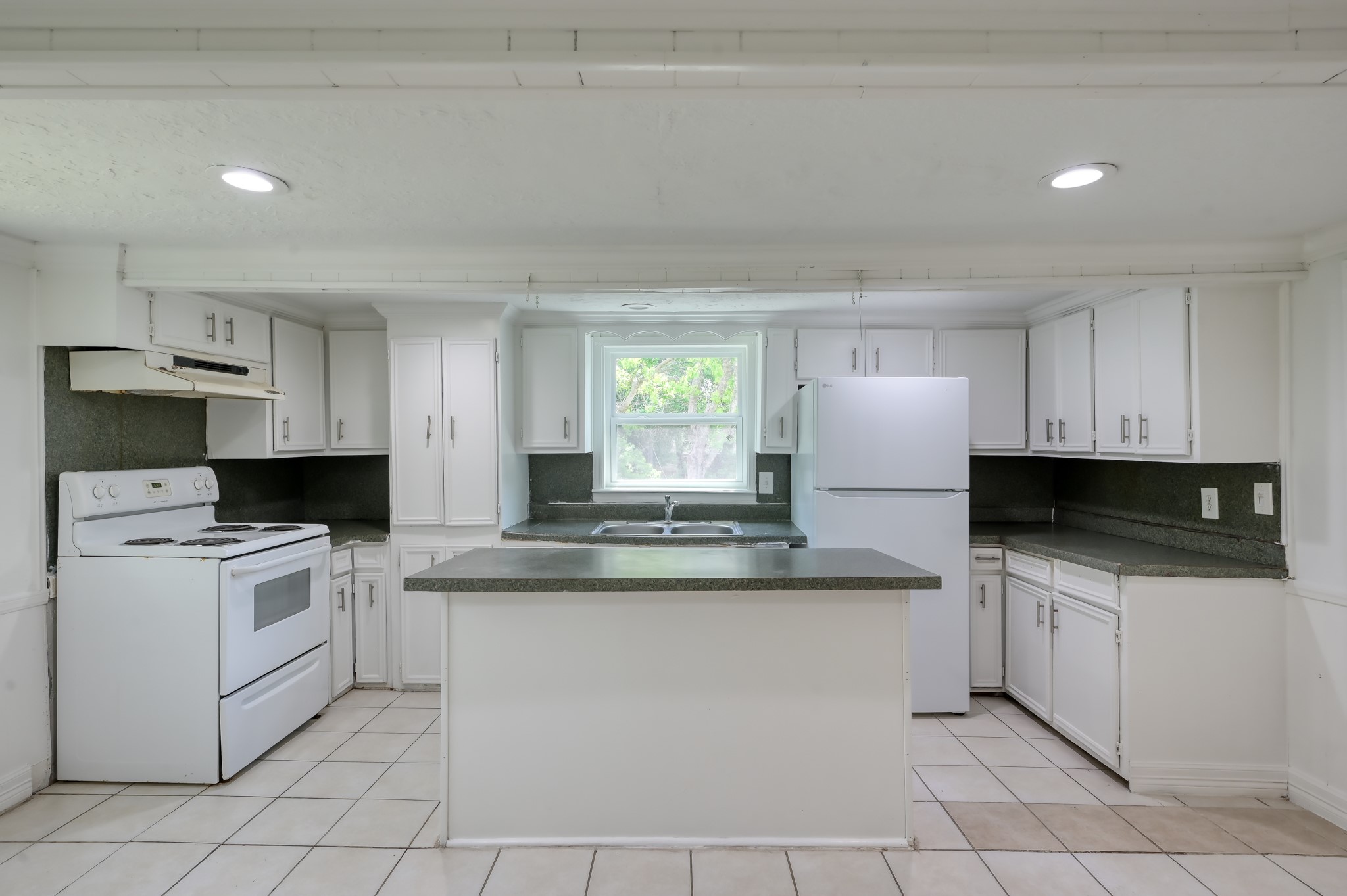 29906 Hunters, Unit B Magnolia, TX 77355 - Photo 10 of 25 a kitchen with stainless steel appliances granite countertop a stove a sink and a refrigerator