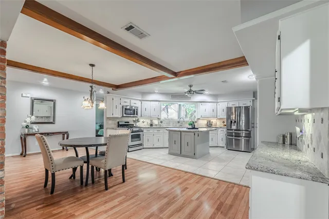 a kitchen with lots of counter top space and painting on the wall