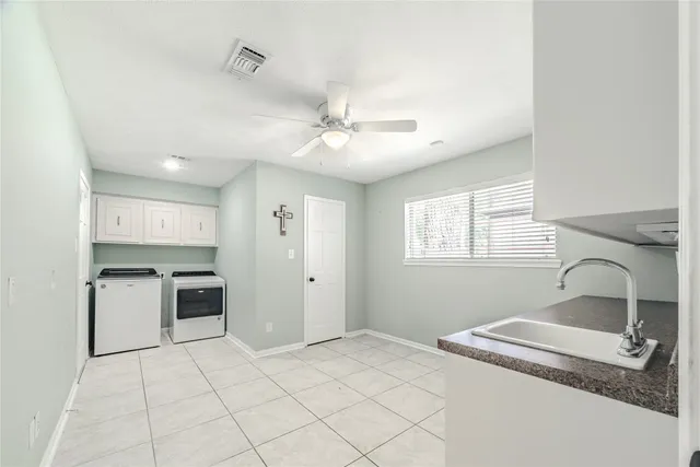 a kitchen with a stove a sink and a refrigerator