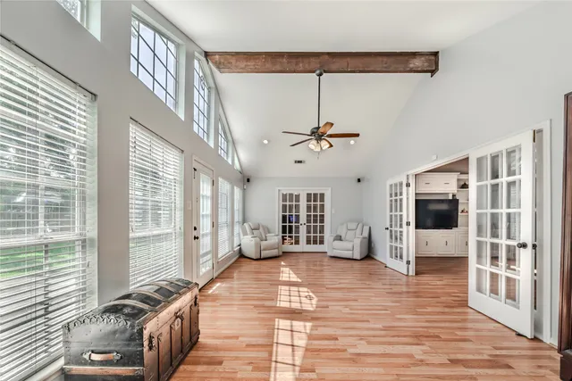 a view of a livingroom with wooden floor and furniture