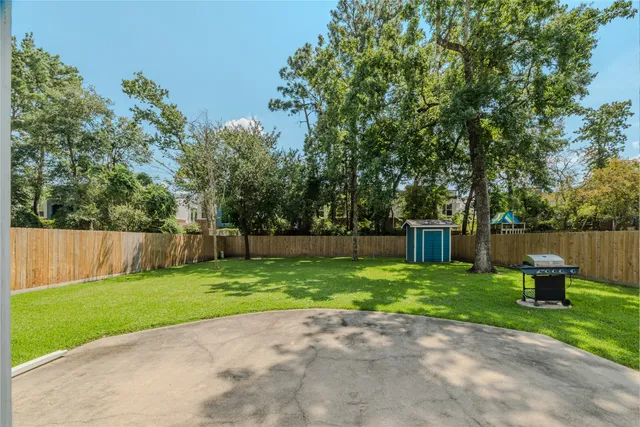 a view of a backyard with potted plants and wooden fence