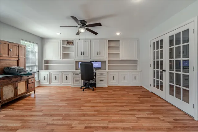 a view of workspace with wooden floor and windows