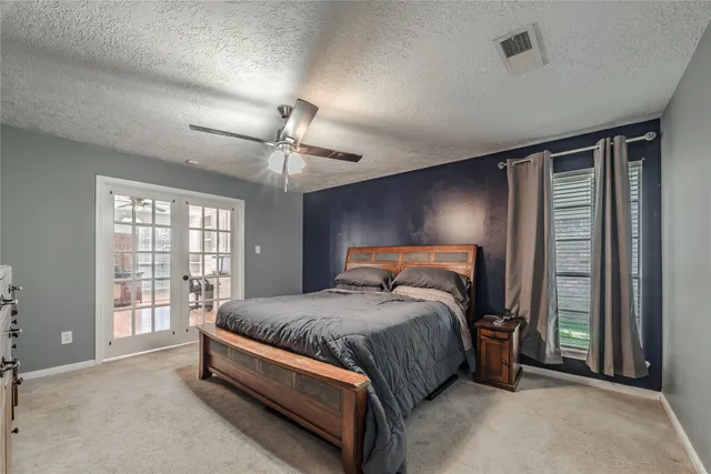 a spacious bedroom with a bed and a large window