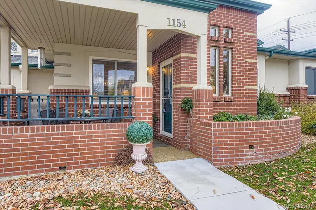 a view of brick house with a chair
