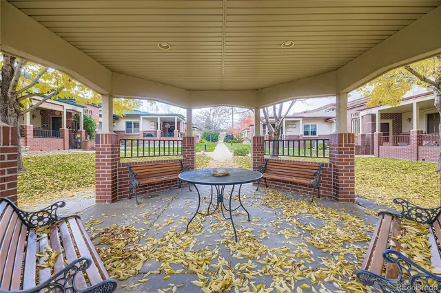 a outdoor space with the couches and dining table with the garden view