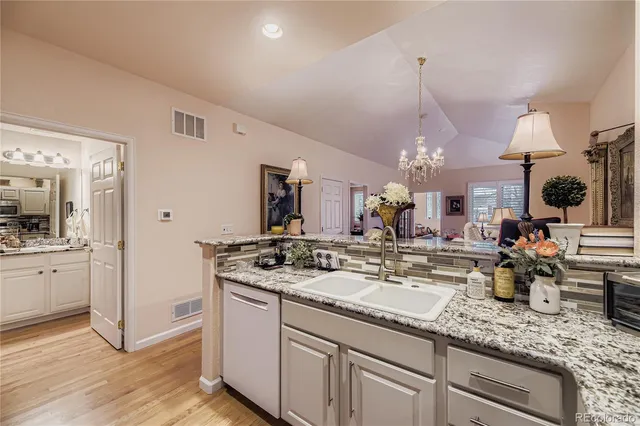 a kitchen with sink stove and refrigerator