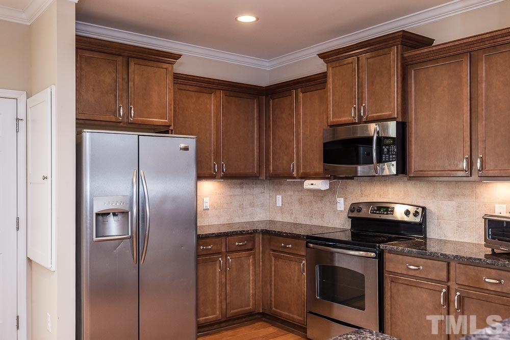 1310 Still Monument Way Raleigh, NC 27603 - Photo 8 of 27 Storage, storage, storage! Love that under cabinet lighting too!