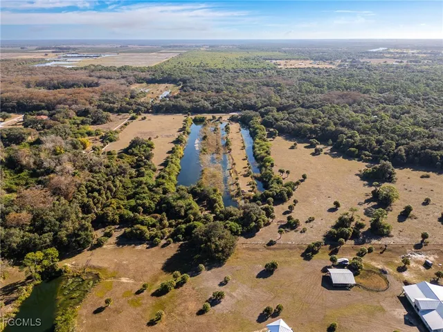 a view of a yard with wooden fence