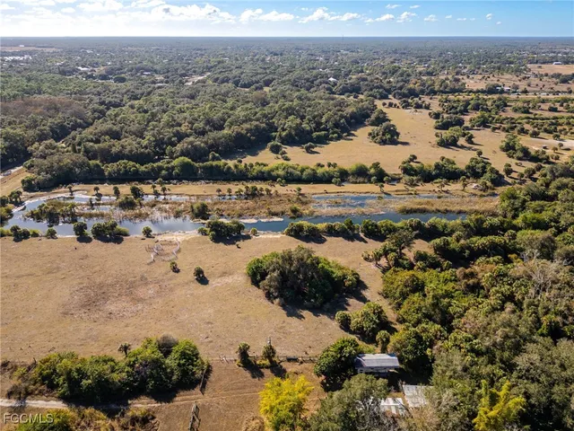 a view of a lake with beach and outdoor space