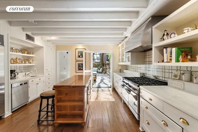 a view of a patio with table and chairs potted plants and a large tree