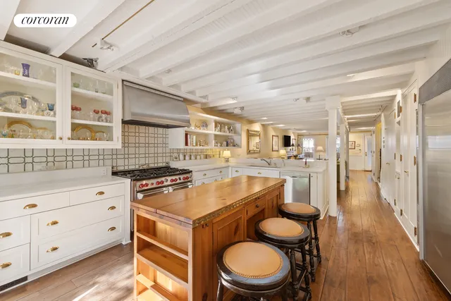 a kitchen with granite countertop a stove a sink and a refrigerator