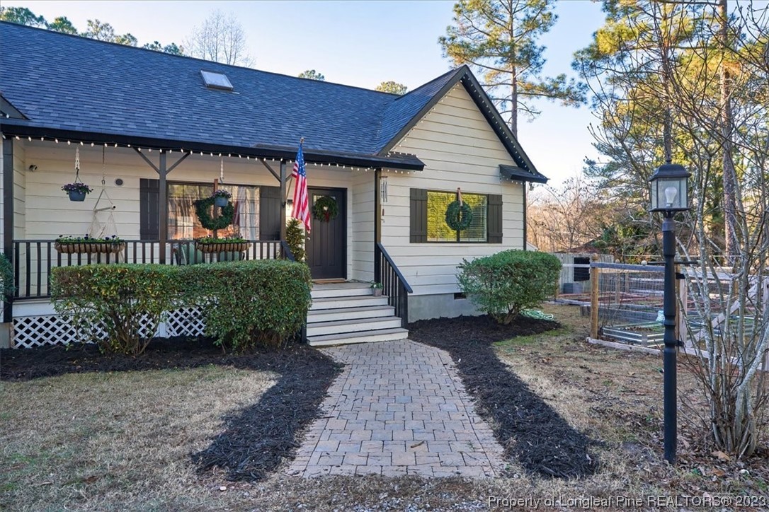 8199 Calloway Road Aberdeen, NC 28315 - Photo 1 of 50 a front view of a house with a garden