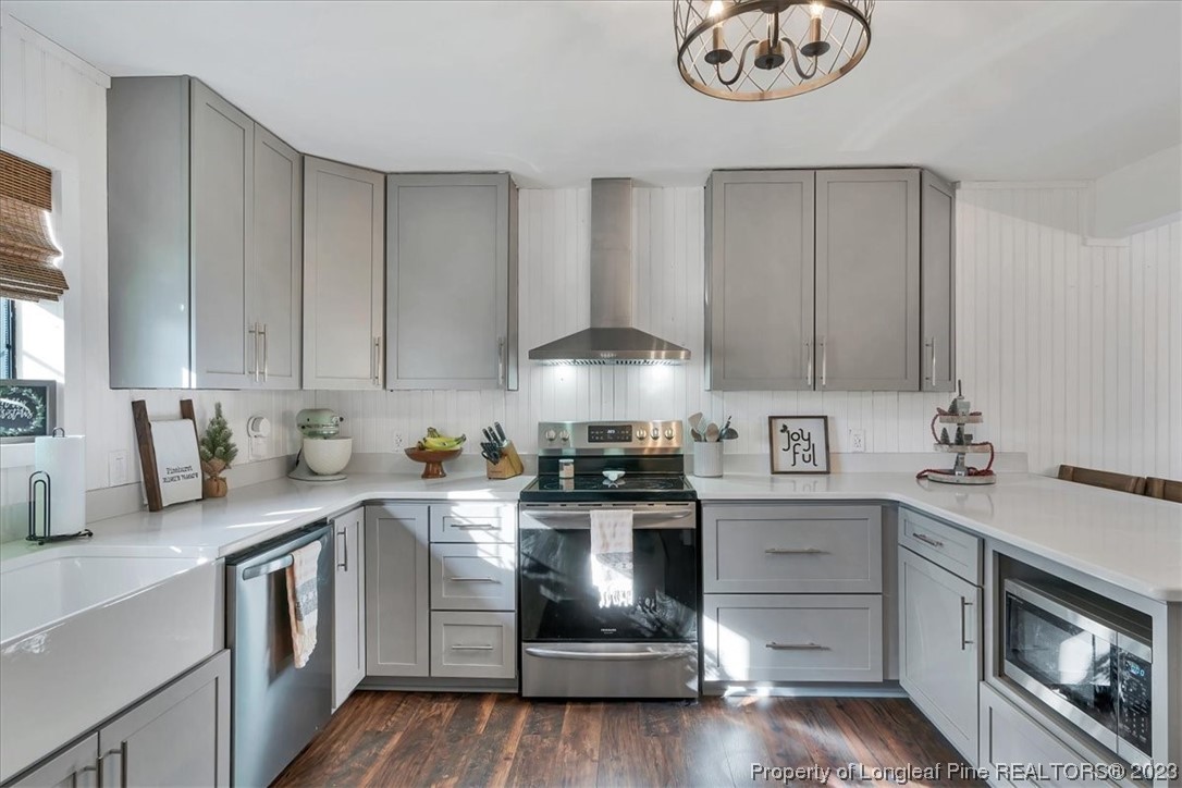 8199 Calloway Road Aberdeen, NC 28315 - Photo 13 of 50 a kitchen with stainless steel appliances granite countertop a sink stove and cabinets
