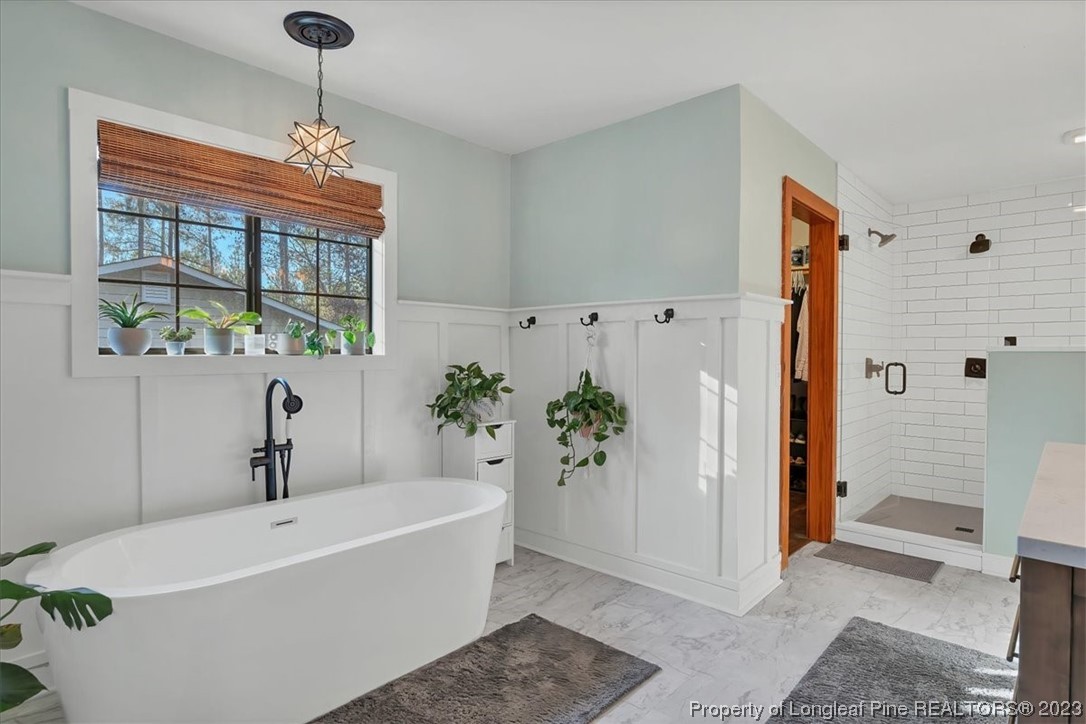 8199 Calloway Road Aberdeen, NC 28315 - Photo 23 of 50 a white bath tub sitting in a bathroom next to a window