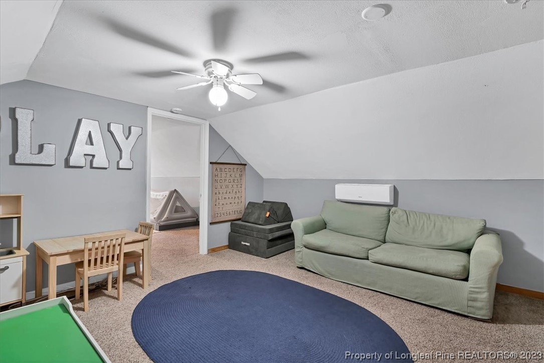 8199 Calloway Road Aberdeen, NC 28315 - Photo 35 of 50 a living room with furniture and a rug