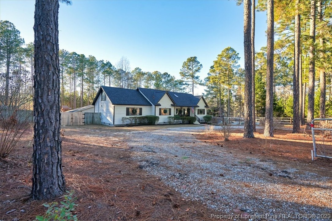 8199 Calloway Road Aberdeen, NC 28315 - Photo 4 of 50 a view of a house with backyard and a trees