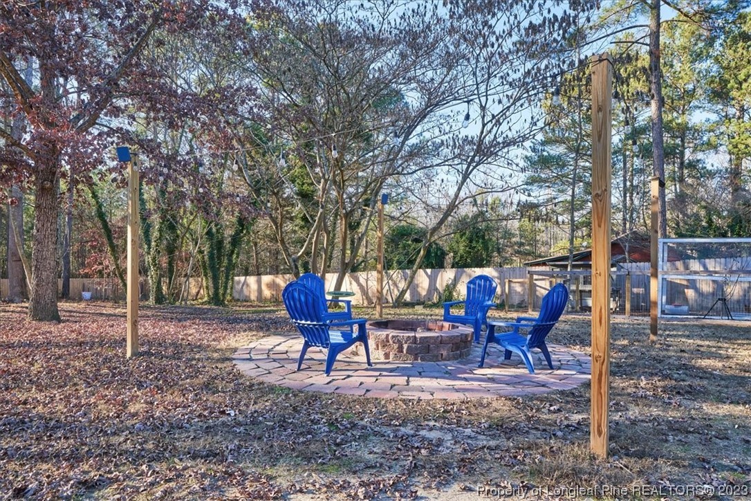 8199 Calloway Road Aberdeen, NC 28315 - Photo 42 of 50 a backyard of a house with outdoor seating