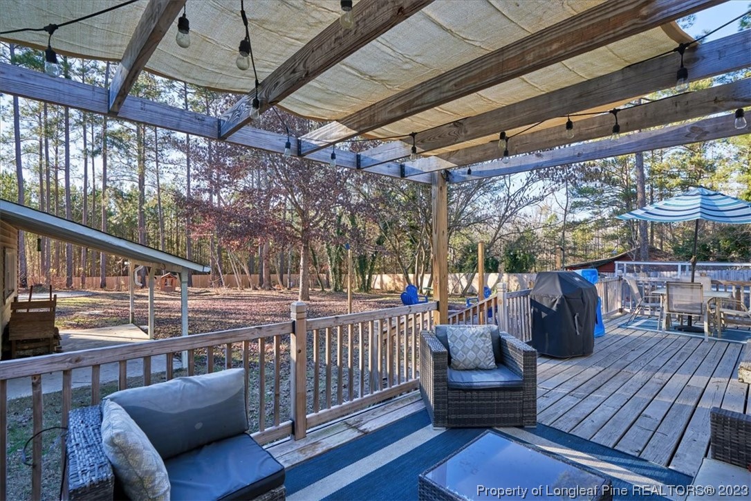 8199 Calloway Road Aberdeen, NC 28315 - Photo 47 of 50 a view of a chair and table on the deck