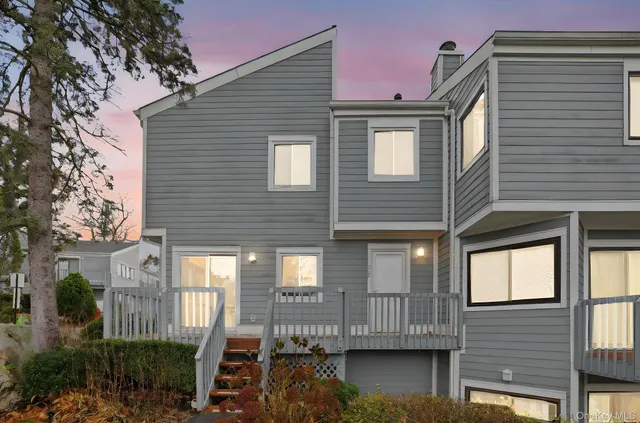 a view of brick house with large windows