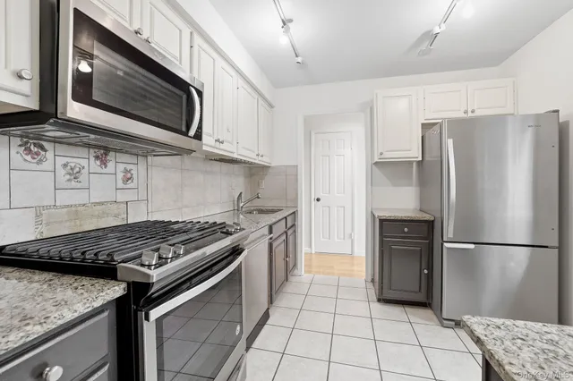 a kitchen with a stove microwave and refrigerator