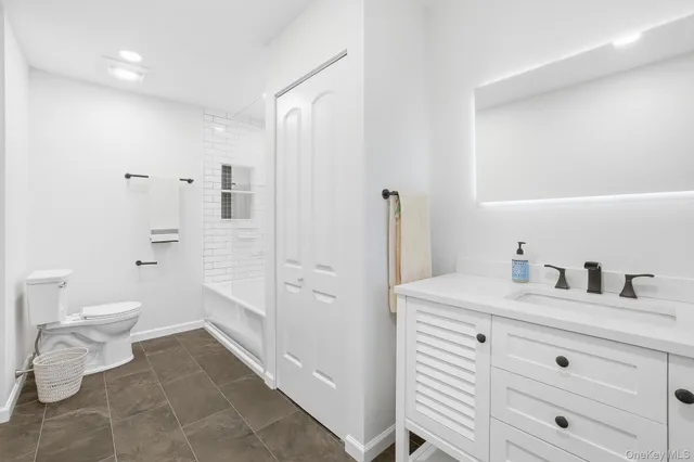 a kitchen with cabinets stainless steel appliances and a counter space