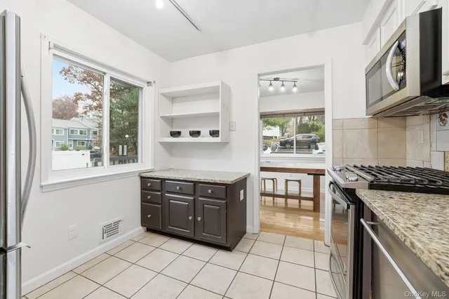 a view of a kitchen with furniture and windows