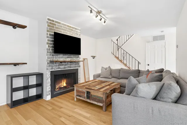a living room with furniture fireplace and flat screen tv