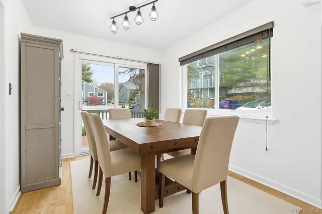 a view of a dining room with furniture large windows and wooden floor