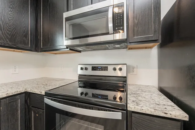 a kitchen with a stove microwave and sink