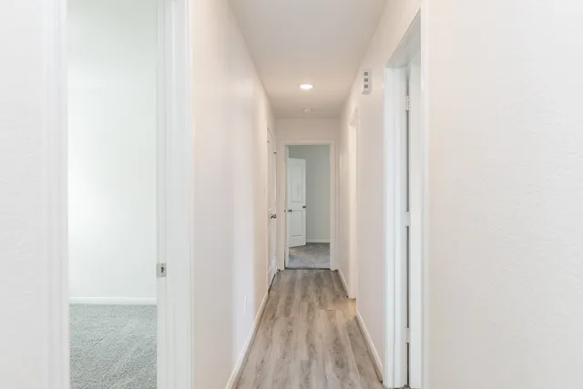a view of a room with wooden floor