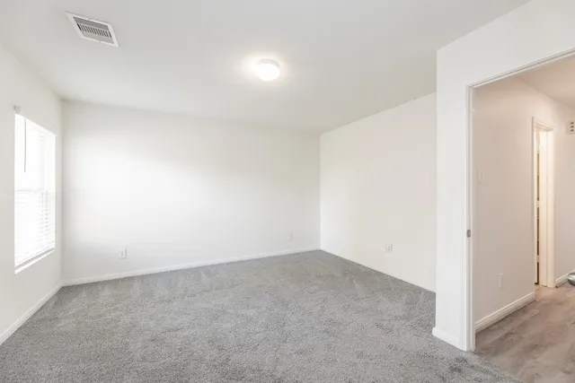 an empty room with a empty space and windows