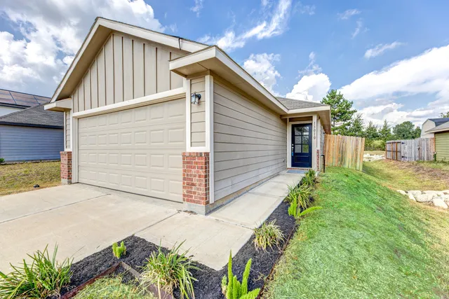 a view of backyard of house with wooden fence