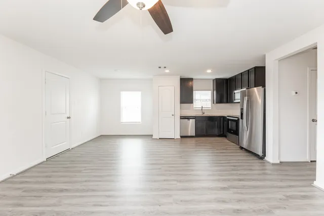 a view of kitchen with refrigerator and window