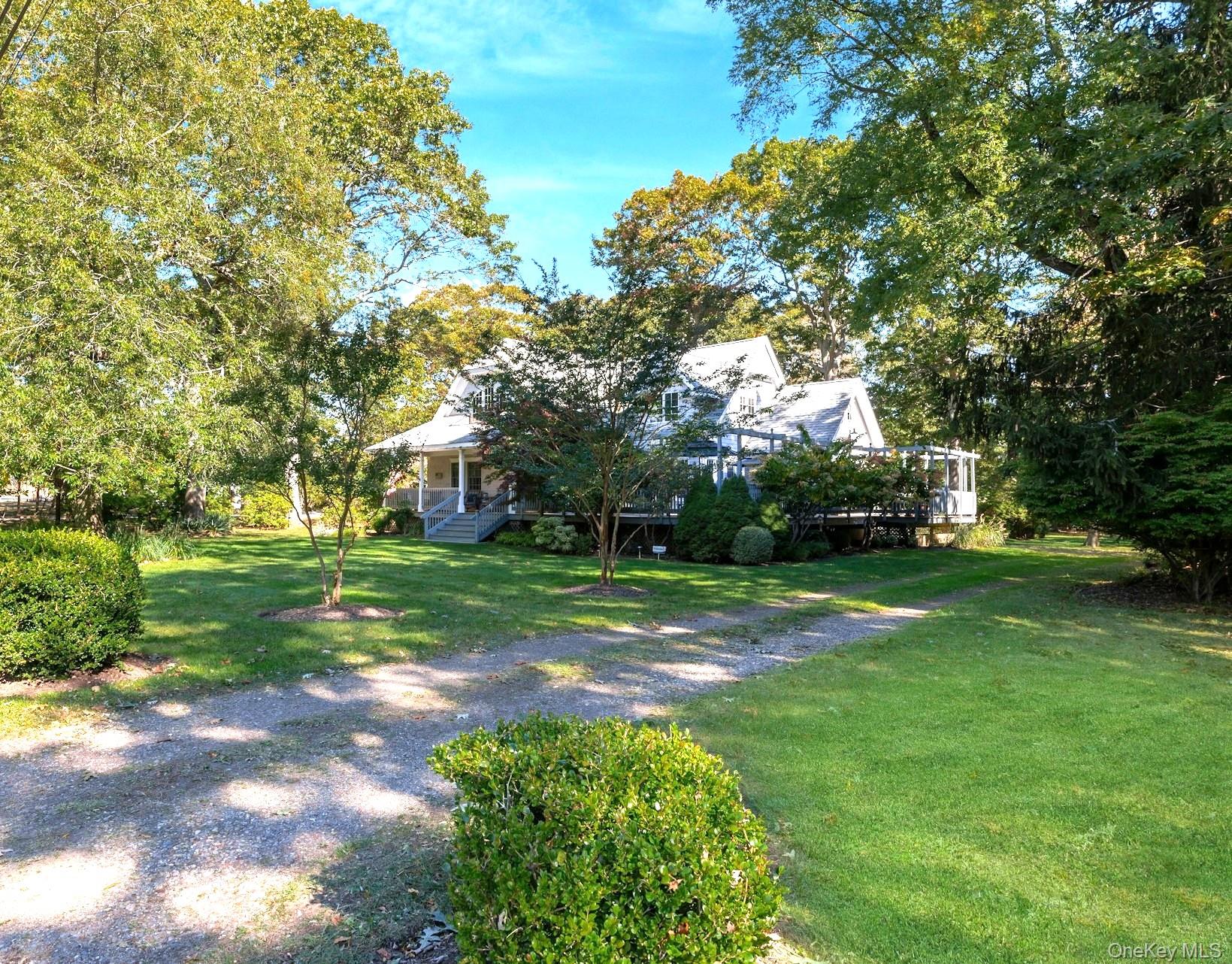 3600 Rocky Point Road East Marion, NY 11939 - Photo 41 of 45 View of green lawn featuring a porch