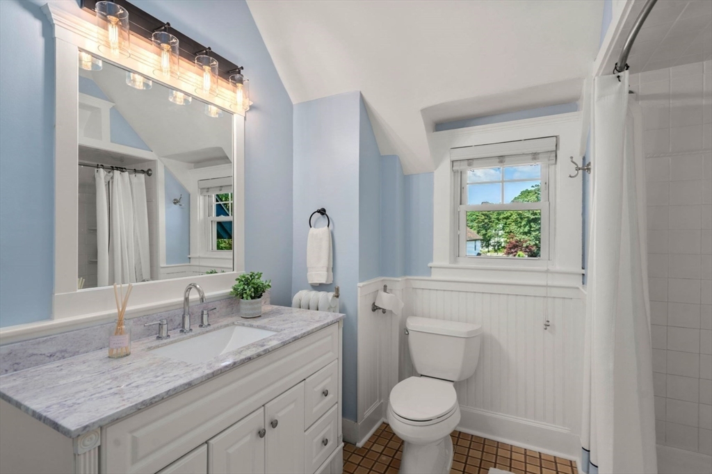 409 Atlantic Avenue Marblehead, MA 01945 - Photo 17 of 29 a bathroom with a granite countertop toilet sink and mirror