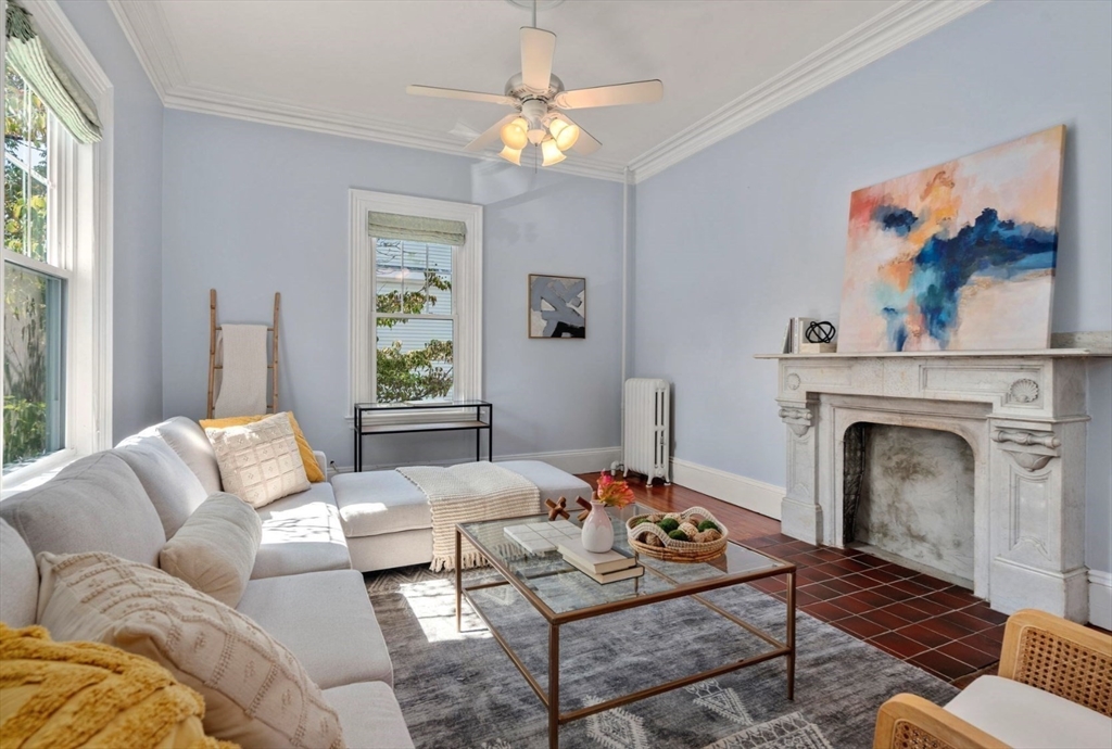 409 Atlantic Avenue Marblehead, MA 01945 - Photo 2 of 29 a living room with furniture a window and a fireplace