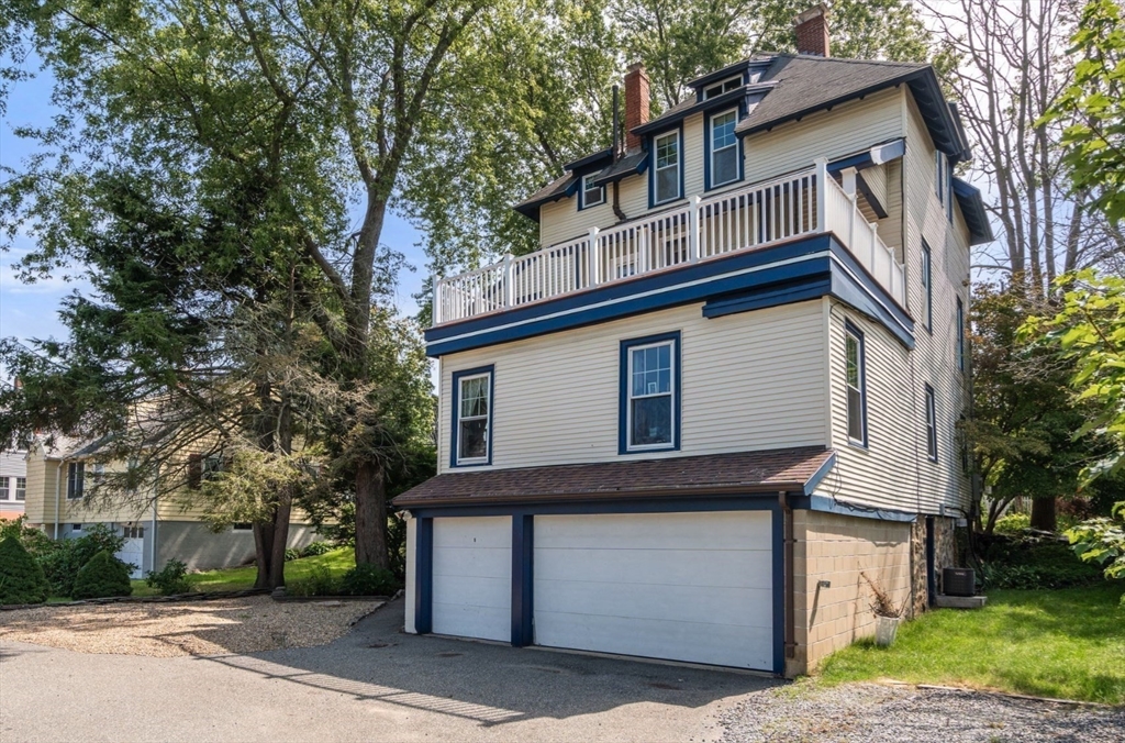 409 Atlantic Avenue Marblehead, MA 01945 - Photo 26 of 29 a front view of a house with a garden