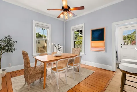 a dining room with furniture a rug and a chandelier